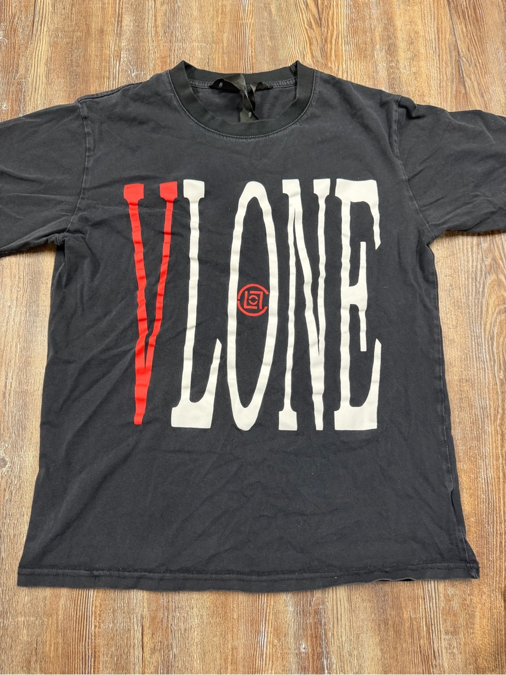 Vlone black tee with white and red 'VLONE' text and small red logo